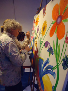 Workshop samen een groot schilderij maken tijdens bedrijfsfeest op lokatie voor op het bedrijf